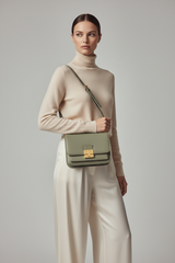 Female model carrying Minimal Luxe Shoulder Bag in Sage Green