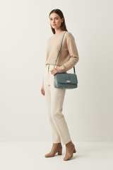 Female model carrying Soft Matte Shoulder Bag in Dusty Aqua