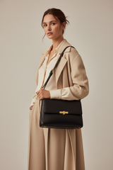 Female model carrying Minimal Luxe Shoulder Bag in Matte Black