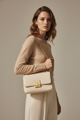 Female model carrying Minimal Luxe Shoulder Bag in Ivory Cream