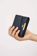 Hand holding Urban Everyday Wallet in Navy and Gold